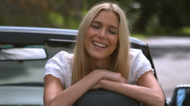 Kvinnan ler mot kameran i hennes bil — Stockvideo