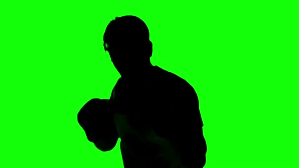 Silhouette eines Mannes, der auf grünem Bildschirm boxt — Stockvideo