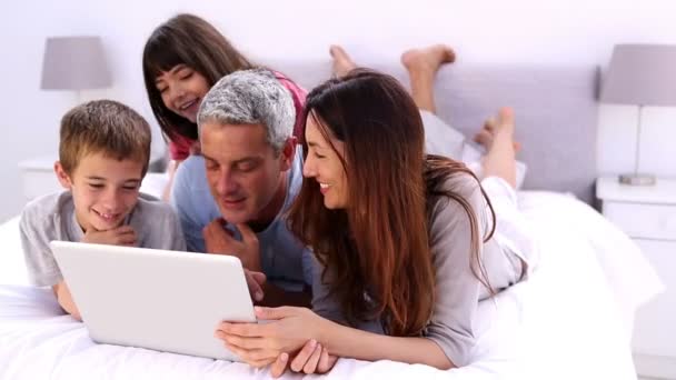 Семья лежит с ноутбуком — стоковое видео