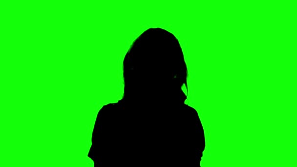 Silhouette einer Frau, die Musik auf grünem Bildschirm genießt — Stockvideo