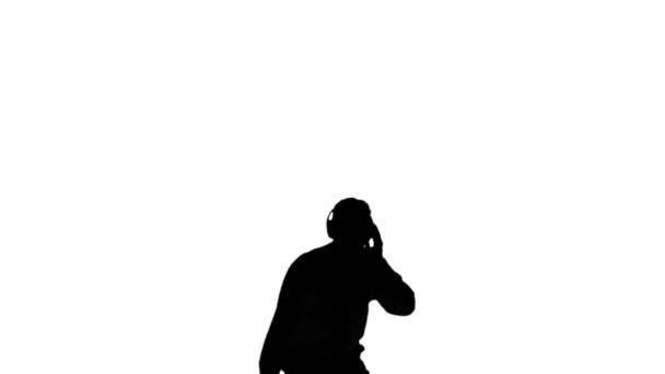 Silhouette of a man enjoying music on white background — Stock Video