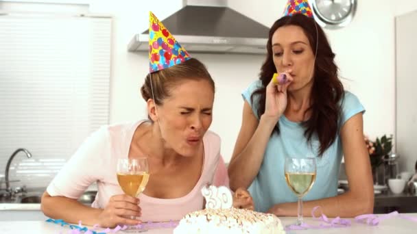 Woman blowing candle while celebrating her birthday with a friend — Stock Video