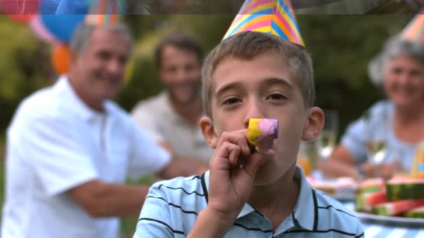 Little boy blowing party horn — Stock Video