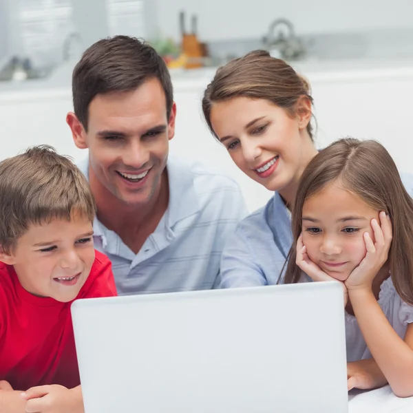 Föräldrar och barn använder en bärbar dator — Stockfoto