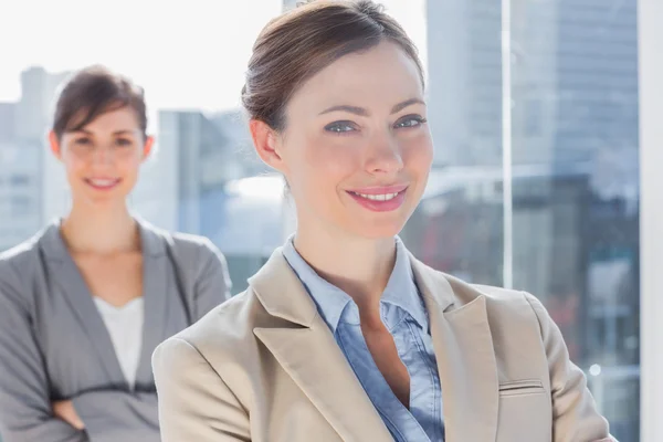 Happy businesswomen with arms crossed — Stock Photo, Image