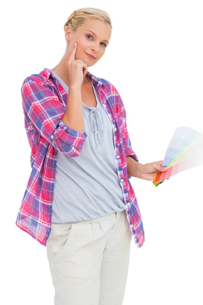 Blonde holding color charts and picking colour — Stock Photo, Image