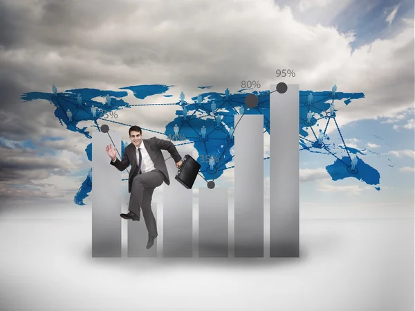 Businessman jumping in front of a chart and a world map — Stock Photo, Image