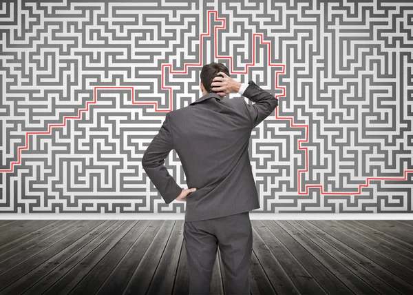 Puzzled businessman looking at a maze — Stock Photo, Image