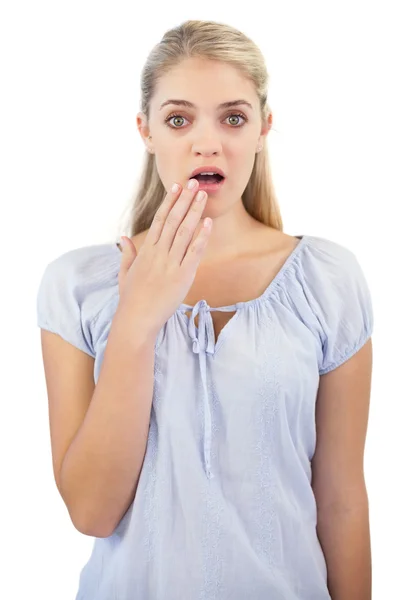 Shocked blonde woman with hand in front of her mouth — Stock Photo, Image