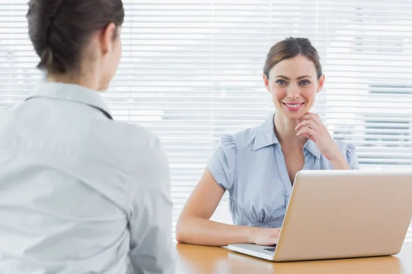 Businesswoman smiling at camera during an interview — Stock Photo, Image