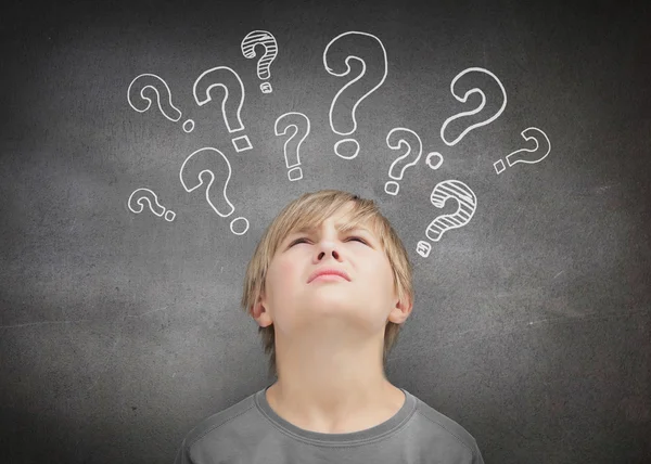 Thinking child looking at question marks — Stock Photo, Image