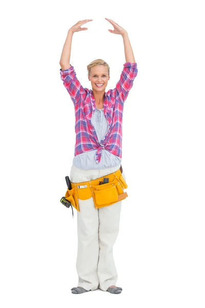 Pretty blonde wearing a tool belt in ballerina pose — Stock Photo, Image