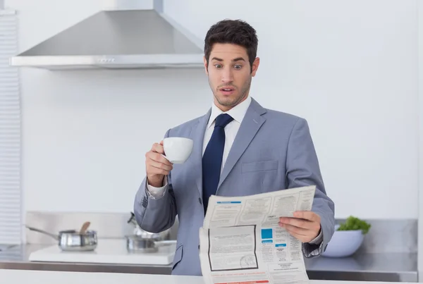 Businessman being astonished when reading the news — Stock Photo, Image