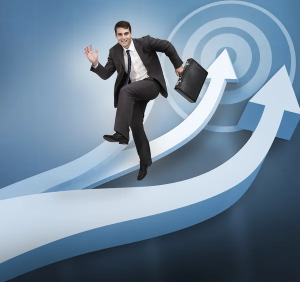 Businessman jumping over blue arrows — Stock Photo, Image