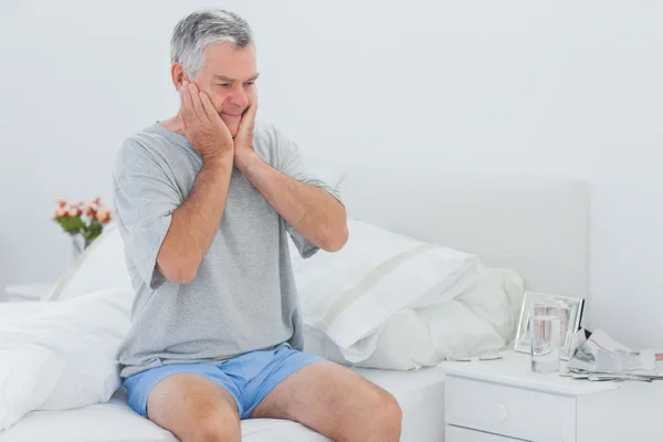 Man about to get off the bed — Stock Photo, Image