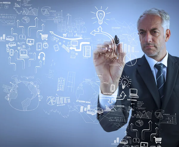 Businessman holding a marker and drawing — Stock Photo, Image