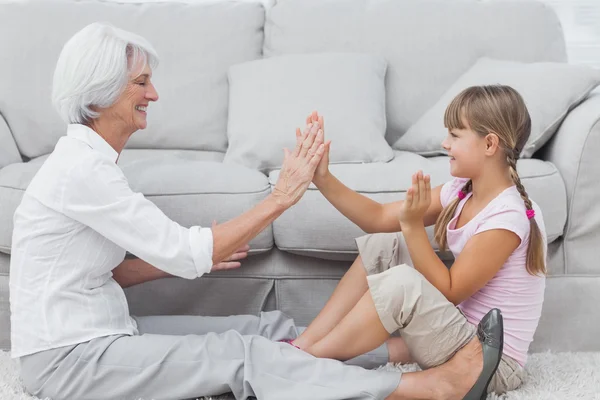 Young girl and grandmother playing together — Stock Photo, Image