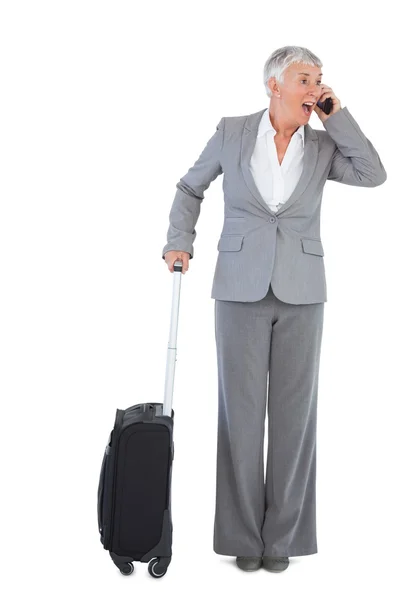 Businesswoman calling and has luggage — Stock Photo, Image