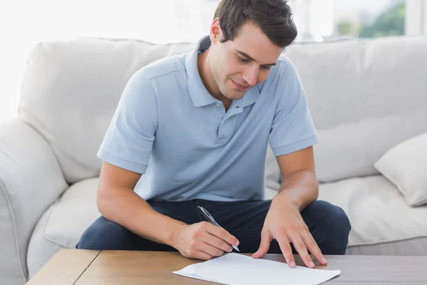 Handsome man writing on a paper Royalty Free Stock Images