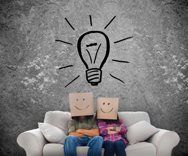 Employees sat on a couch with a light bulb drawing — Stock Photo, Image