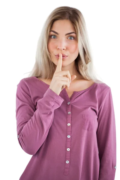 Young woman with finger on her lips — Stock Photo, Image