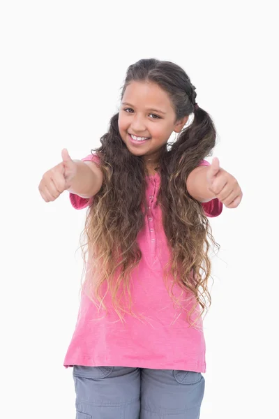 Little girl does thumbs up at camera — Stock Photo, Image