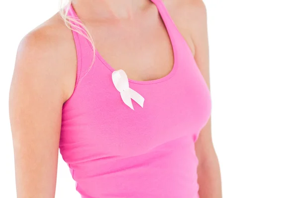 Woman wearing pink top and ribbon for breast cancer — Stock Photo, Image