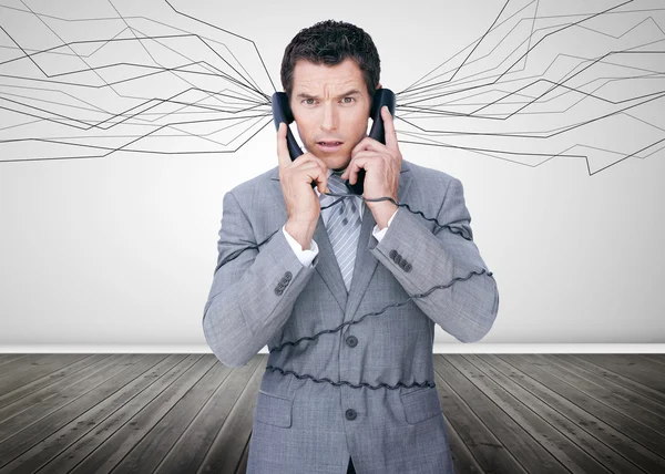 Businessman trapped by telephone wires — Stock Photo, Image