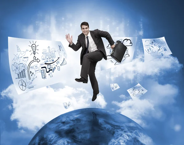 Businessman jumping over a planet with drawings floating — Stock Photo, Image