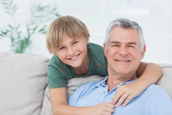 Portrait of grandson embracing grandfather — Stock Photo, Image