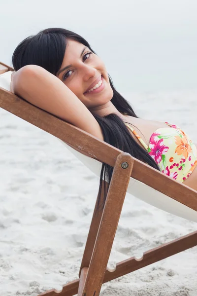 Beautiful woman resting on deck chair — Stock Photo, Image