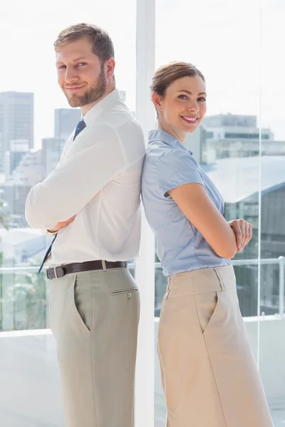 Smiling business team standing back to back — Stock Photo, Image