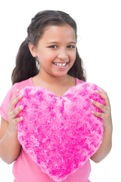 Little girl holding cushion in the shape of a heart — Stock Photo, Image