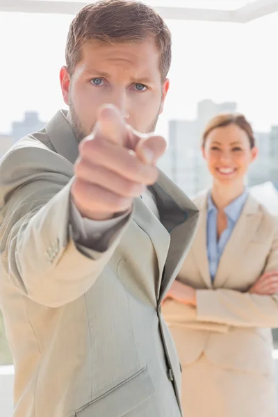 Annoyed businessman pointing at camera — Stock Photo, Image