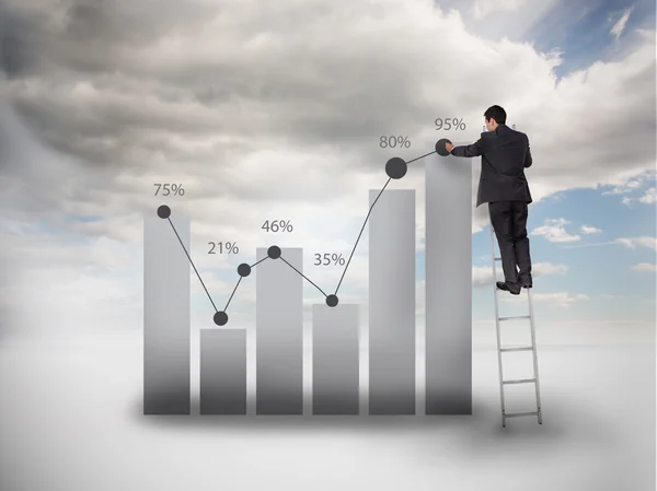 Businessman standing on a ladder drawing a chart — Stock Photo, Image