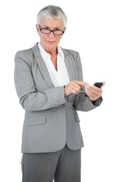 Geschäftsfrau mit Brille benutzt ihr Handy — Stockfoto