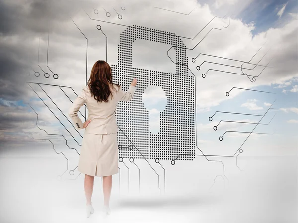 Businesswoman selecting a padlock — Stock Photo, Image