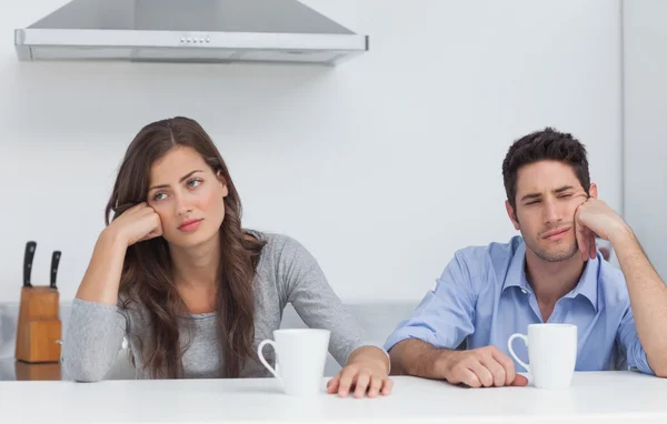 Tired couple sitting at the table with a cup of coffee — Stock Photo, Image