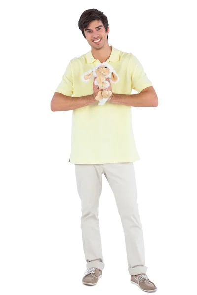 Happy man holding a sheep plush — Stock Photo, Image