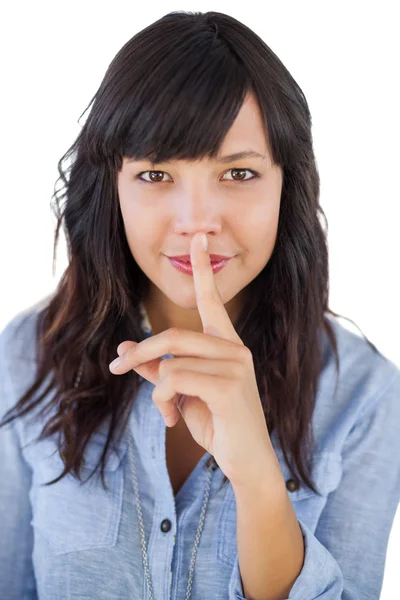 Brunette putting finger on her mouth for silence — Stock Photo, Image