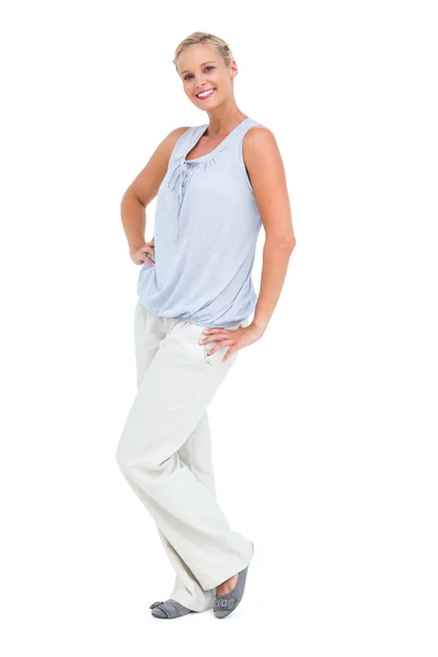 Blonde standing with her hands on her hips smiling at camera — Stock Photo, Image