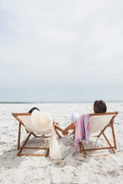 Couple looking ocean on their deck chairs — Stock Photo, Image