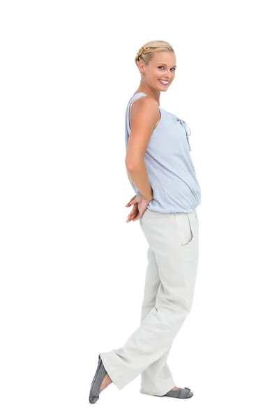 Woman looking at camera with hands behind her back — Stock Photo, Image