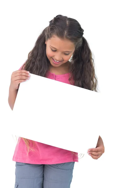 Little girl holding and looking at sign — Stock Photo, Image