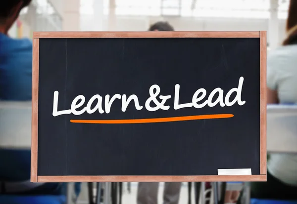 Learn and lead written on blackboard — Stock Photo, Image
