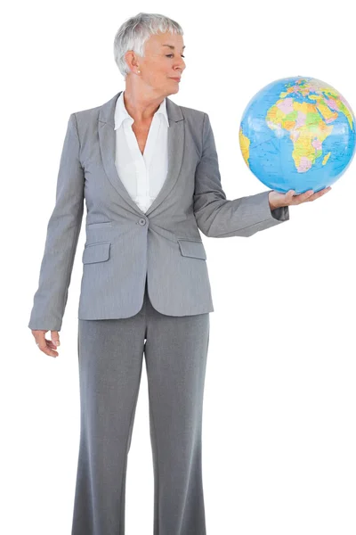 Businesswoman holding and looking at globe — Stock Photo, Image