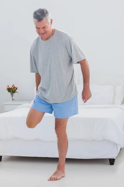 Mature man stretching his leg — Stock Photo, Image