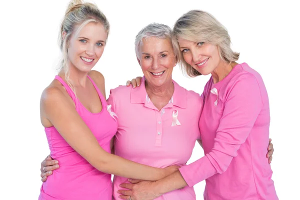 Mujeres felices con tops rosas y cintas para el cáncer de mama — Foto de Stock