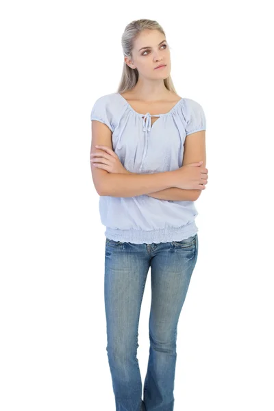 Thinking blonde woman crossing her arms — Stock Photo, Image