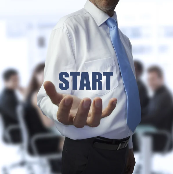 Businessman holding the word start — Stock Photo, Image